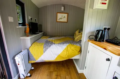 a bedroom with a bed in a small room at Woodpeckers in Llandrindod Wells