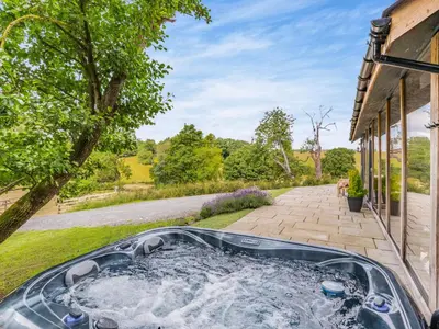 a hot tub in the backyard of a house at The Hideaway in Highgate