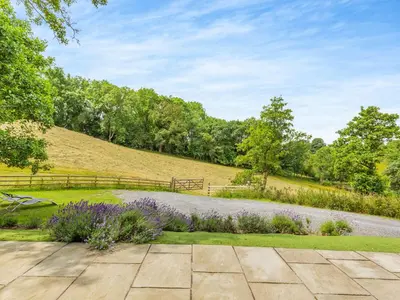 a garden with purple flowers and a fence at The Hideaway in Highgate