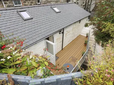 an overhead view of a house with a wooden deck at Glan Meon Cottage in Barmouth