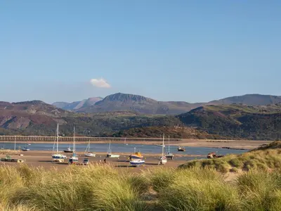 a bunch of boats are docked in a harbor at Glan Meon Cottage in Barmouth