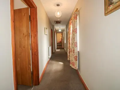 a hallway of a house with a door and a hallwayngth at The Onibury in Craven Arms