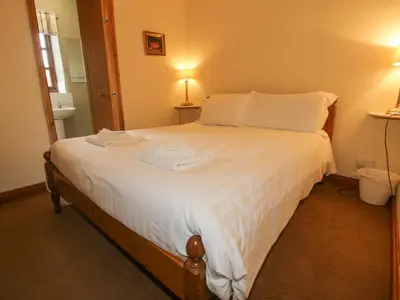 a bedroom with a bed with two towels on it at The Onibury in Craven Arms