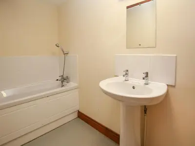 a bathroom with a sink and a mirror and a bath tub at The Walton in Craven Arms