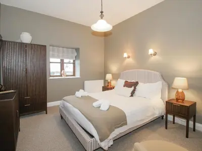 a bedroom with a bed with white sheets and pillows at The Park in Craven Arms