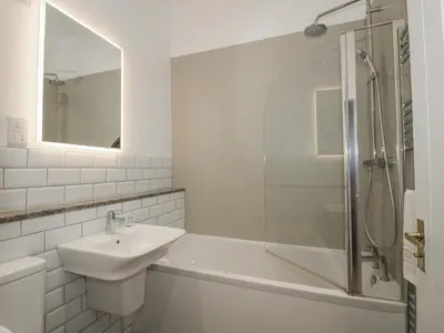 a white bathroom with a sink and a shower at The Park in Craven Arms