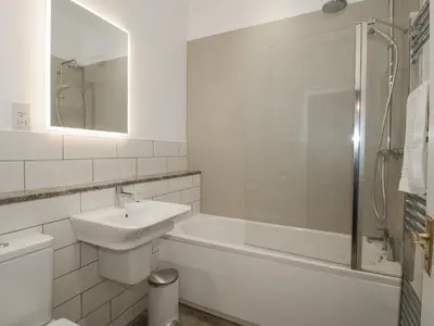 a bathroom with a sink and a tub and a toilet at The Park in Craven Arms