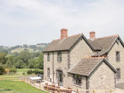 an old brick house with a gray roof at The Farm in Presteigne