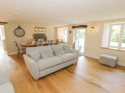 a living room with a couch and a table at Tyn Ffynnon in Dyffryn