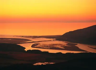 an aerial view of a river at sunset at Lovely Large home 10 Minute Walk to Barmouth Beach in Barmouth