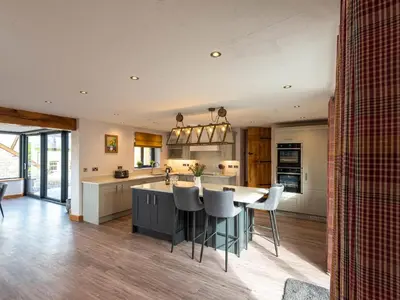 a kitchen with a table and chairs in a room at Granar in Derwen