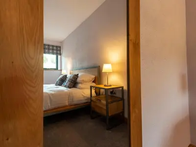 a bedroom with a bed and a mirror at Granar in Derwen