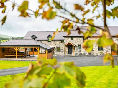 a stone building with a pavilion in front of it at Granar in Derwen