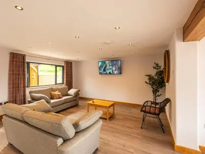 a living room with a couch and a table at Granar in Derwen