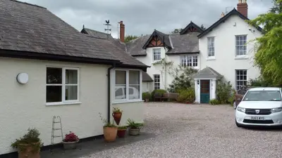 a white car parked in front of a house at Willow Cottage in North Lydbury
