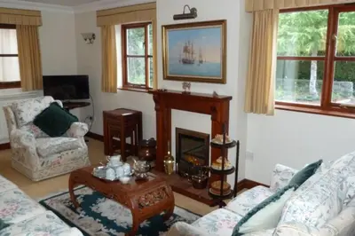 a living room with a couch and a fireplace at Willow Cottage in North Lydbury