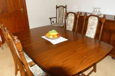 a wooden table with a bowl of fruit on it at Willow Cottage in North Lydbury