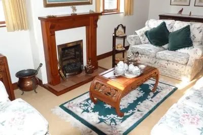 a living room with a couch and a coffee table at Willow Cottage in North Lydbury