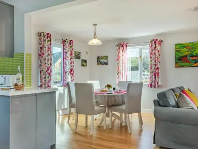 a kitchen and living room with a table and chairs at Cuckoo Hill Lodge in Saint Harmon