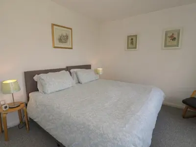a bedroom with a large bed with two pillows at Hafod-y-Gors in Fairbourne