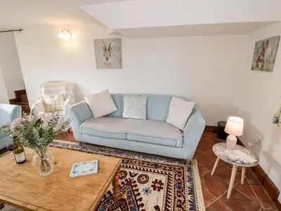 a living room with a couch and a table at Wilstone Cottage in Church Stretton