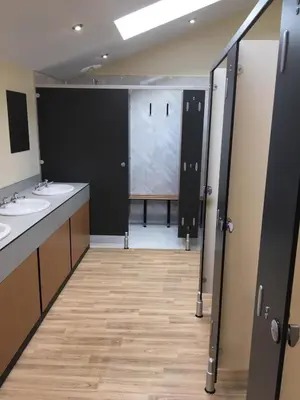 a bathroom with two sinks and two stalls at Shepherds Hut at Wern Mill in New Quay
