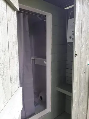a walk in shower with a purple shower curtain at Cae Mawr Yurt Off-Grid Glamping in Machynlleth