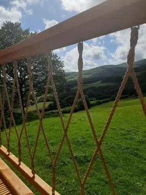 a fence with a view of a green field at Cae Mawr Yurt Off-Grid Glamping in Machynlleth