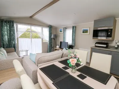a living room with a couch and a table at Ystwyth 26 in Borth