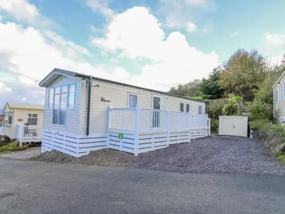 a tiny house is parked in a driveway at Ystwyth 26 in Borth