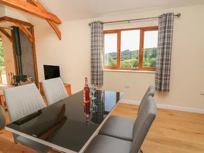 a dining room with a table and chairs at Ploony Hill Cabin in Knighton