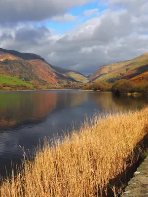 a view of a lake with hills in the background at Snowdonia Hideaway in Tywyn