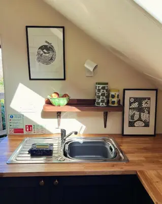 a kitchen with a sink and a counter top at Snowdonia Hideaway in Tywyn