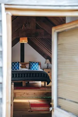 a bedroom with a bed with blue pillows at the garden room in Shrewsbury