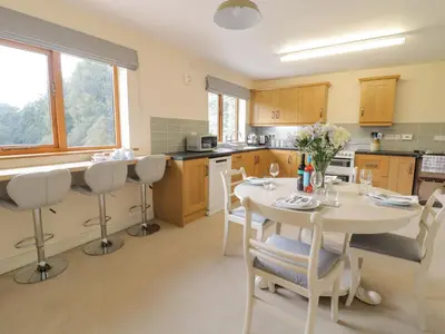 a kitchen with a table and chairs in it at Hendre in Oswestry