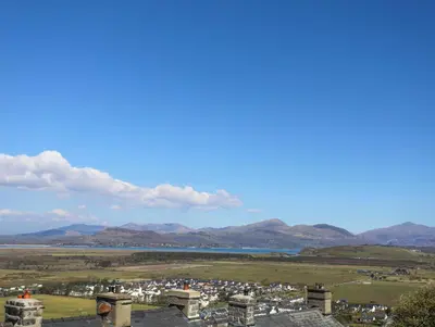 a view from the observatory of the city and mountains at Harlech Apartments - Efnisien in Harlech