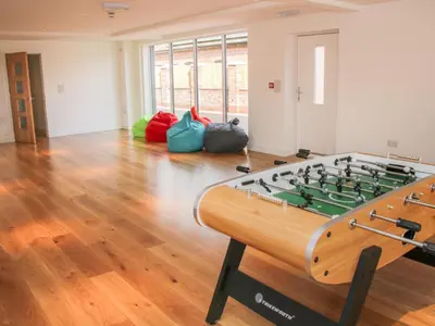 a room with a foosball table in the middle of a room at Black Lion Barn Retreat in Shrewsbury