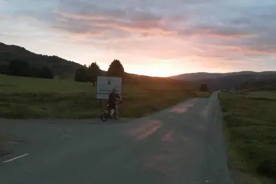 a person riding a bike down a road at Bwthyn Gweilch in Machynlleth