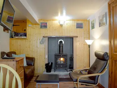 a living room with a fireplace and a couch at Paramount Cottage in Farden
