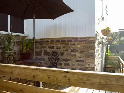 a patio with a table and an umbrella at Paramount Cottage in Farden