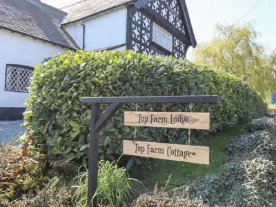 a sign that says top farm house and top farm cottage at Top Farm Lodge in Oswestry
