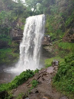 a waterfall on the side of a mountain at Gwilym's Stable in Builth Wells