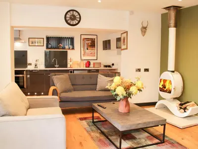 a living room with a couch and a fire place at Bank House Barn in Shrewsbury