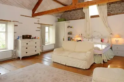 a living room with a couch and a bed at The Hillis Farmhouse - 6 Bed - Sleeps 11 - Pets in Brecon