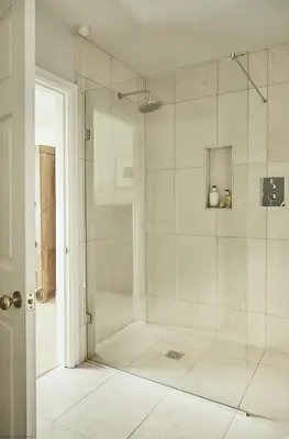 a shower with a glass door in a bathroom at Tan Llan in Dolgellau
