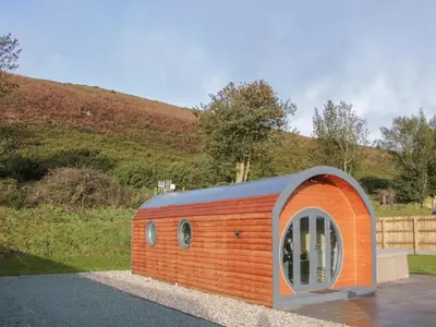 a small house with an orange and blue roof at Stapeley Pod in Shrewsbury