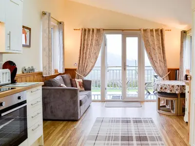 a kitchen and living room with a couch and a window at Tyncoed - Uk32238 in Lower Chapel