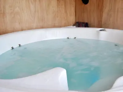 a bath tub filled with lots of blue water at Tyncoed - Uk32238 in Lower Chapel