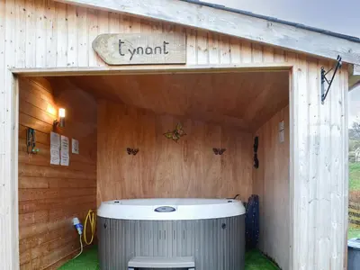 aoutside view of a wooden building with a hot tub at Ty Nant - Uk32239 in Lower Chapel