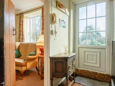 a living room with a couch and a window at Pen Y Crug in Beulah